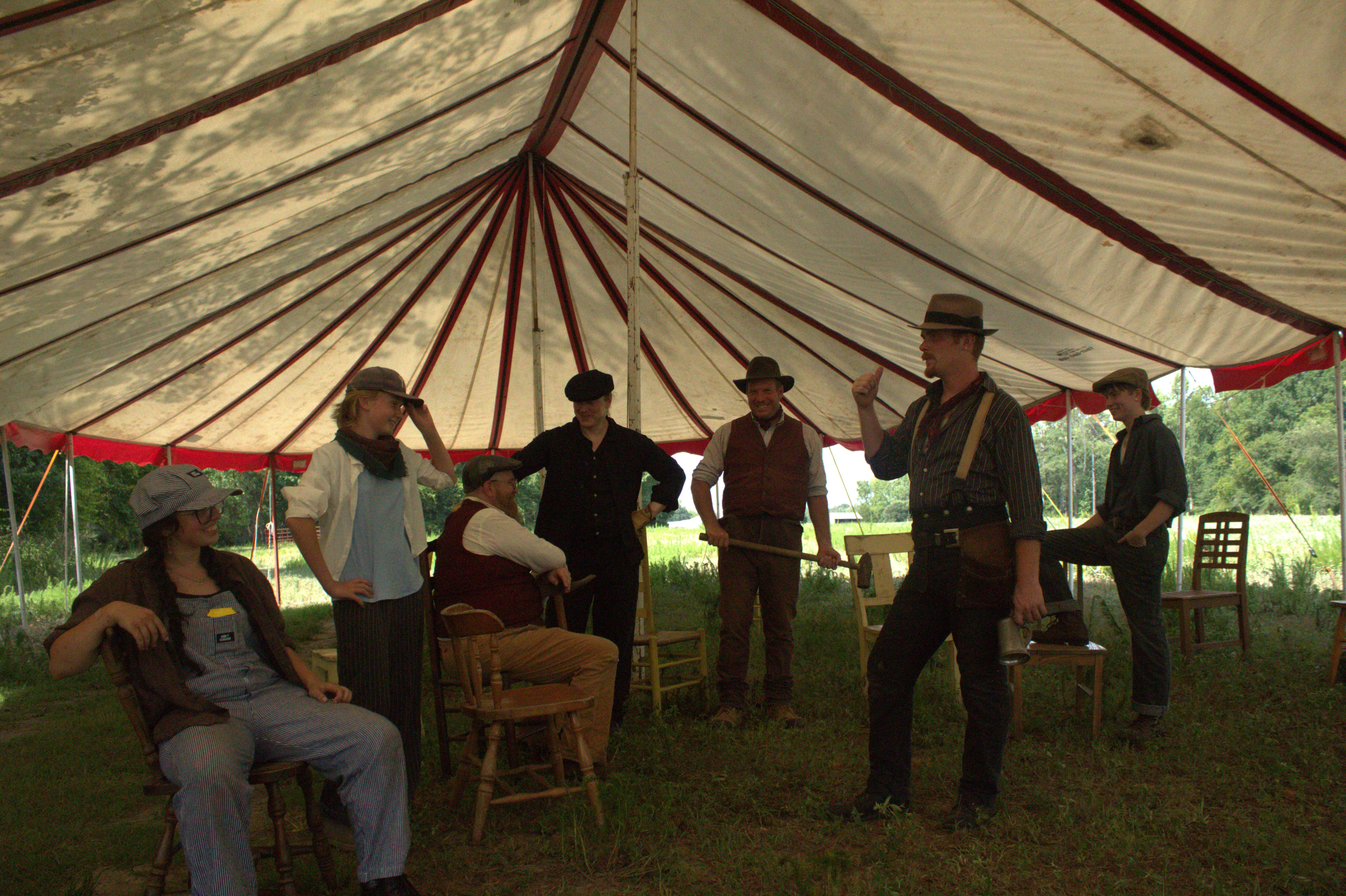 The company posed in front of the tent